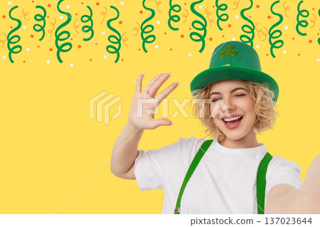 Young woman in green hat waves on St Patricks Day Young woman in green hat waves on St Patricks Day 137023644