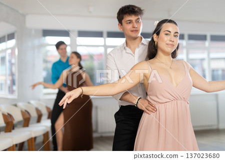 During rehearsal, guy and girl participants of dance workshop perform figure waltz During rehearsal, guy and girl participants of dance workshop perform figure waltz 137023680