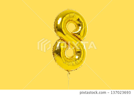 Golden balloon in the shape of number 8 stands out Golden balloon in the shape of number 8 stands out 137023693