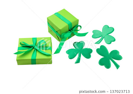 Green gift boxes with ribbons and shamrock decorations, isolated, PNG 137023713