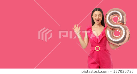Young woman stands with a balloon in shape of eight Young woman stands with a balloon in shape of eight 137023753