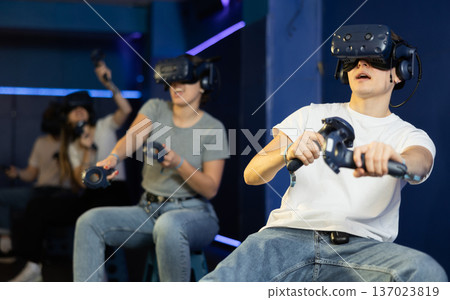 Excited guy having fun with friends in virtual reality room 137023819