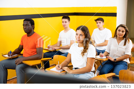 Portrait of group of people in lecture hall at extension courses Portrait of group of people in lecture hall at extension courses 137023823