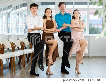 Girls and guy dancing folk dance in row in dance studio 137023845