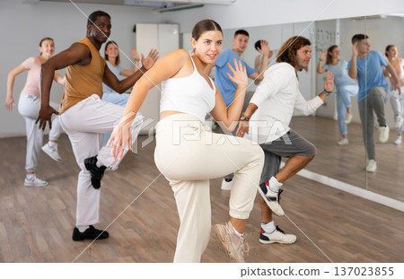 Group of different people rehearsing dance in dance studio 137023855