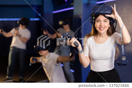 girl is exhilarated by turn of events in VR game and moved virtual reality glasses to forehead girl is exhilarated by turn of events in VR game and moved virtual reality glasses to forehead 137023888