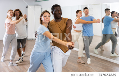 Man and woman in pairs learning to dance waltz in studio 137023889