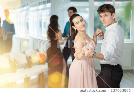 During rehearsal, guy and girl participants of dance workshop perform social pair dance During rehearsal, guy and girl participants of dance workshop perform social pair dance 137023965
