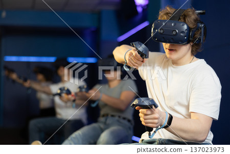 Man in virtual reality glasses controls superhero with joystick in exciting action game simulator 137023973