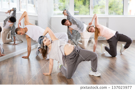 Young girl practicing breakdance floor-works in training hall Young girl practicing breakdance floor-works in training hall 137023977