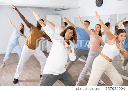 Group of different people rehearsing dance in dance studio Group of different people rehearsing dance in dance studio 137024004