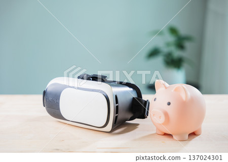 pink piggy bank for money, metaverse banking, casino vr and ar saving concept features technology, virtual reality headset on wooden desk for digital finance and global investment pink piggy bank for money, metaverse banking, casino vr and ar saving concept features technology, virtual reality headset on wooden desk for digital finance and global investment 137024301