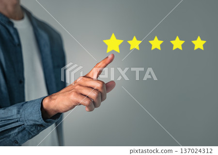Customer five star review rate concept with hand pressing for a good rating shown on the screen, reflecting positive feedback showing a reputable customer experience Customer five star review rate concept with hand pressing for a good rating shown on the screen, reflecting positive feedback showing a reputable customer experience 137024312