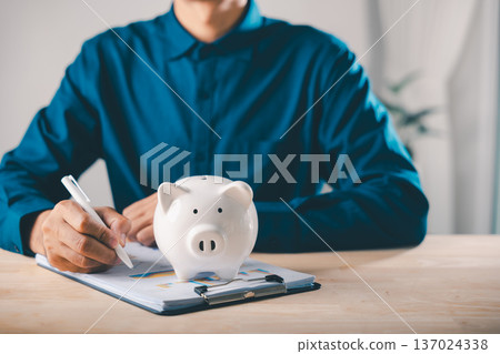 Piggy bank finance money documents save management check document help man organize budget, professional office worker analyzes investment report statistics on wooden desk clipboard Piggy bank finance money documents save management check document help man organize budget, professional office worker analyzes investment report statistics on wooden desk clipboard 137024338