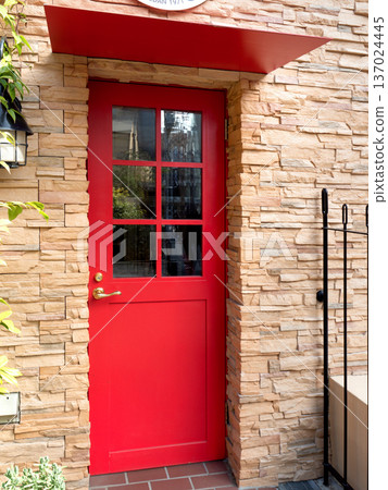 Stone-grained walls and a bright red door Stone-grained walls and a bright red door 137024445