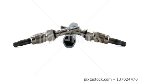 Two glow plugs and a wrench set against a bright, clean, minimalist white backdrop. 137024470