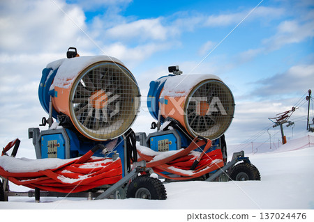 Snow Cannons at Ski Resort Covered in Snow Near Chairlift on Cloudy Winter Day Snow Cannons at Ski Resort Covered in Snow Near Chairlift on Cloudy Winter Day 137024476