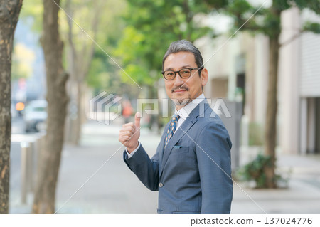 A businessman in his 50s making a fist pump A businessman in his 50s making a fist pump 137024776