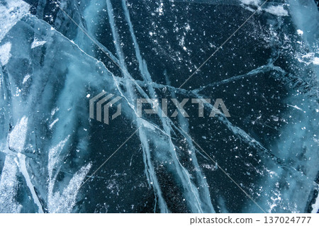 Beautiful cracks surface of the frozen lake Baikal in winter season. Baikal is the largest freshwater lake and the world's deepest lake. Beautiful cracks surface of the frozen lake Baikal in winter season. Baikal is the largest freshwater lake and the world's deepest lake. 137024777