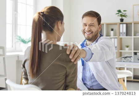 Positive Doctor Consulting Patient In Hospital Positive Doctor Consulting Patient In Hospital 137024813