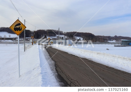 Retro railway crossing sign and Lavender Farm Station in mid-winter (towards Farm Tomita) Retro railway crossing sign and Lavender Farm Station in mid-winter (towards Farm Tomita) 137025160