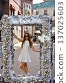 Woman posing in silver Christmas arch on Rodeo Drive Beverly Hills 137025603