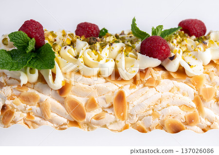 Meringue cream cheese roll with raspberries, mint and nuts. Meringue cream cheese roll with raspberries, mint and nuts. 137026086