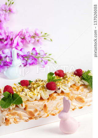 Easter meringue cream cheese roll with raspberries and nuts. 137026088