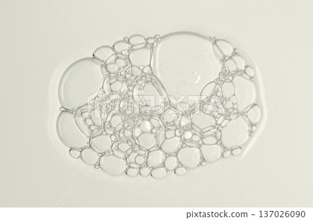 Sample of the foam of shower gel or soap suds or shaving foam. Macrophotography. 137026090