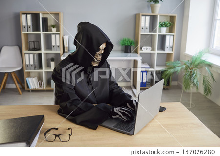Grim Reaper Using Laptop For Online Activity In Office Grim Reaper Using Laptop For Online Activity In Office 137026280