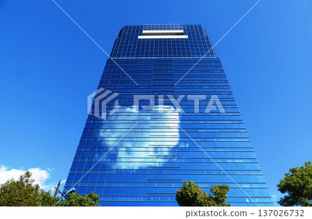Heart-shaped cloud reflected on curtain wall building 137026732