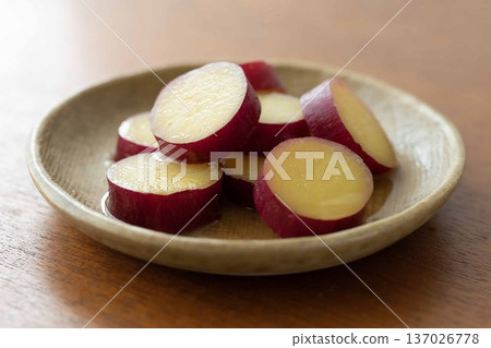 Candied sweet potatoes on a wooden table Candied sweet potatoes on a wooden table 137026778