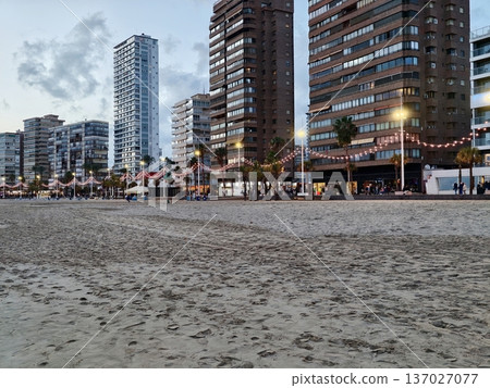 Nighttime promenade with vibrant activities, Bright coastal boardwalk bustling with entertainment Nighttime promenade with vibrant activities, Bright coastal boardwalk bustling with entertainment 137027077
