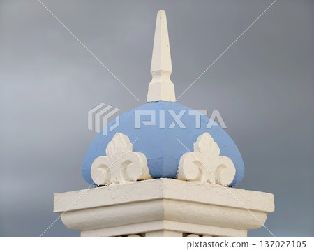 Skillfully crafted artistic image of decorative blue dome with finial beneath turbulent weather conditions Skillfully crafted artistic image of decorative blue dome with finial beneath turbulent weather conditions 137027105
