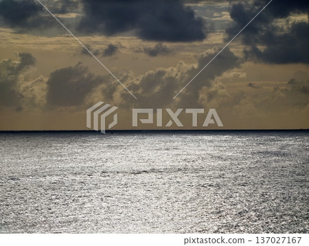 Serene coastal scene, Tranquil sea view under warm clouds with glowing water ideal for wellness promotion 137027167
