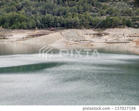 Serene lake with sandy shorelines, Calm freshwater space with exposed sandy banks and reflective surface Serene lake with sandy shorelines, Calm freshwater space with exposed sandy banks and reflective surface 137027198