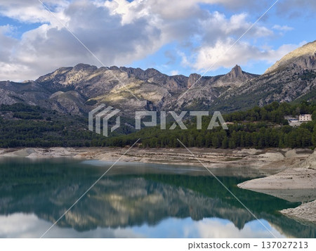 Peaceful home on tranquil waters, Quiet countryside dwelling nestled near shimmering emerald lake Peaceful home on tranquil waters, Quiet countryside dwelling nestled near shimmering emerald lake 137027213