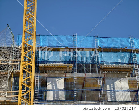 Building site panorama, Construction environment showcasing highrise framework and lifting machinery 137027217