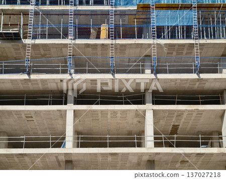 Raw construction aesthetics, Unfinished concrete floors reveal framework and raw building textures 137027218