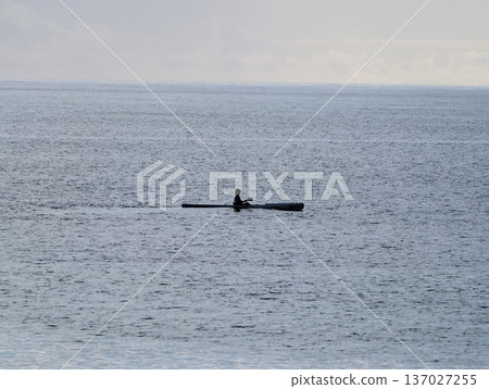 Serene kayaking during sunset, Solitary paddling across gentle ocean waves under fading light of day Serene kayaking during sunset, Solitary paddling across gentle ocean waves under fading light of day 137027255