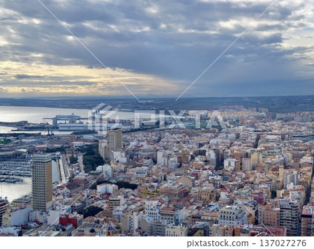 Cargo port during golden hour, Shipping terminal at sunset with industrial and water reflections 137027276