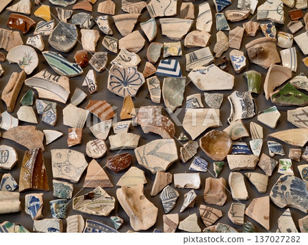 Old tile mosaic, Vintage ceramic broken pieces arranged in dense mosaic suitable for garden pathways Old tile mosaic, Vintage ceramic broken pieces arranged in dense mosaic suitable for garden pathways 137027282