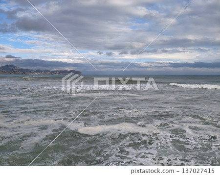 Expansive oceanic landscape with hills, Wide coastal scene featuring distant promontory and clouds Expansive oceanic landscape with hills, Wide coastal scene featuring distant promontory and clouds 137027415