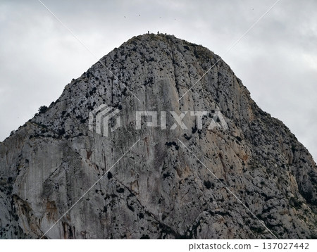 Massive stone structure ascends into overcast sky with striking contours and silent grandeur 137027442