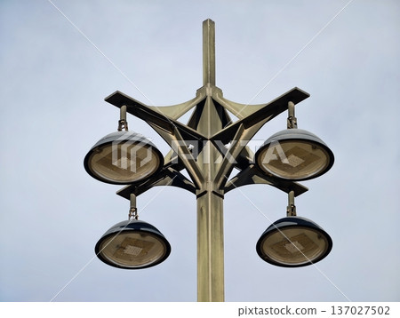 Sleek circular streetlamps with modern design, Stylish streetlight featuring round lamps and metal arms Sleek circular streetlamps with modern design, Stylish streetlight featuring round lamps and metal arms 137027502