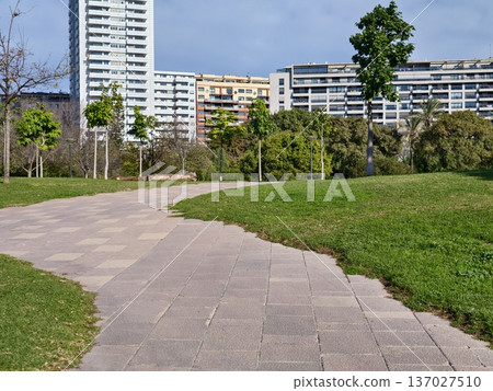 Twisting promenade next to contemporary housing development with wellmaintained landscape areas 137027510