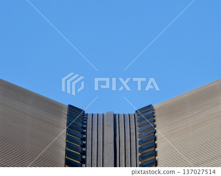 Detailed photograph showcasing uniform metal roofing panels against vibrant blue urban background Detailed photograph showcasing uniform metal roofing panels against vibrant blue urban background 137027514