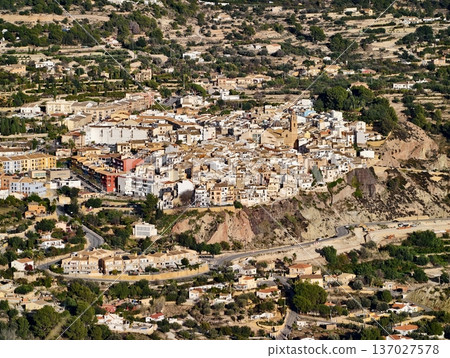 Landscape with rugged cliffs surrounds settlement, Settlement nestled among ochre slopes and cliffs Landscape with rugged cliffs surrounds settlement, Settlement nestled among ochre slopes and cliffs 137027578