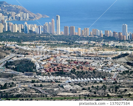 Housing patchwork near ocean and greens, Developer observes sprawling area of houses and seaside greens 137027584