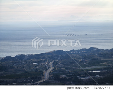 Serene aerial depiction of shoreline roads extending towards distant islands and rolling hills Serene aerial depiction of shoreline roads extending towards distant islands and rolling hills 137027585
